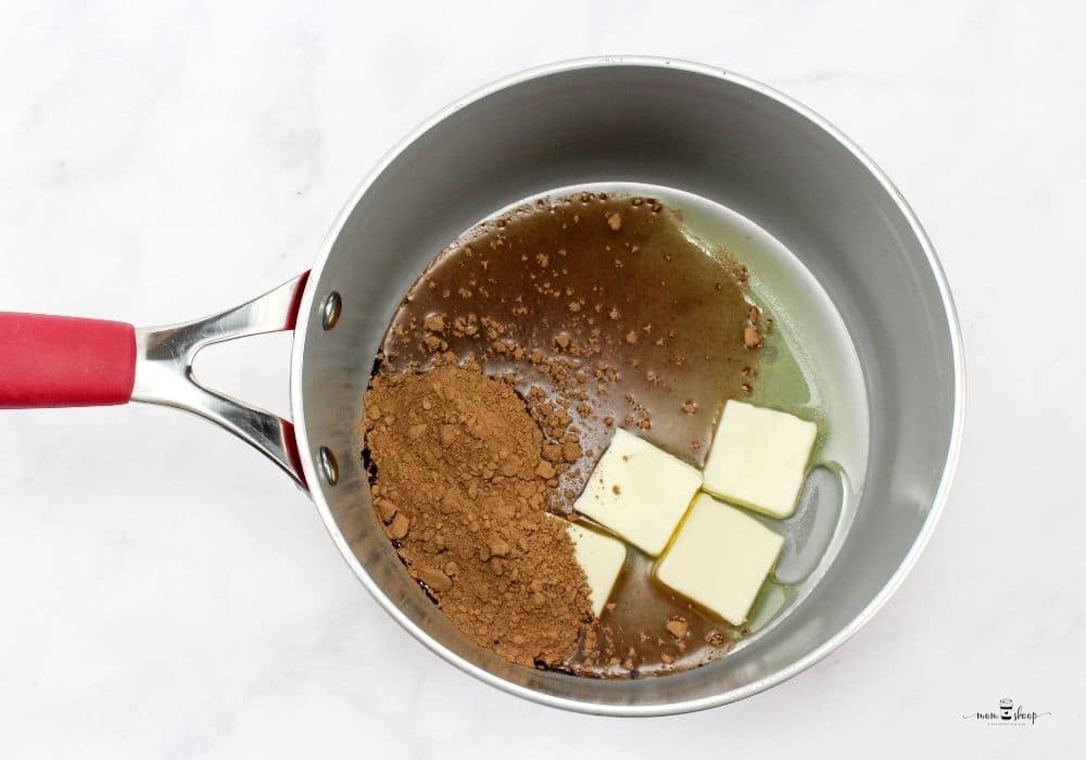 Cocoa powder, butter, oil, water in a saucepan