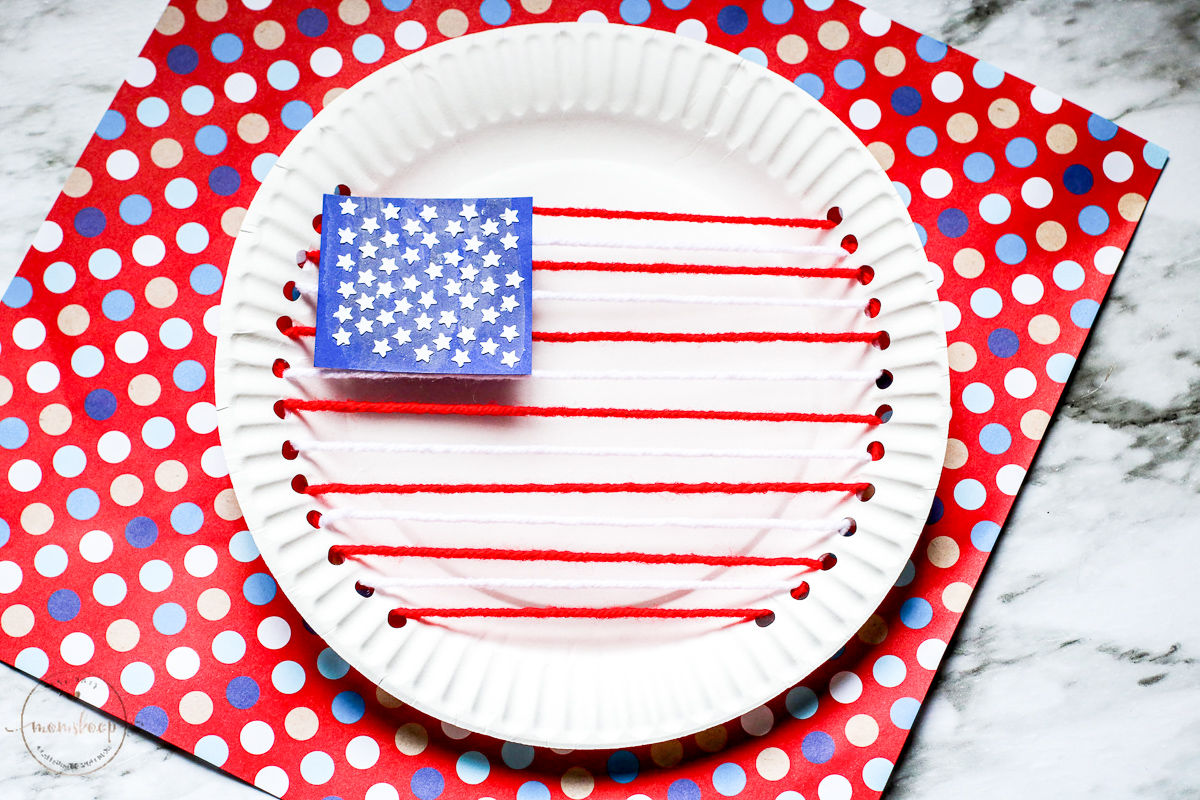 American Flag made our of red and white yarn and paper plates