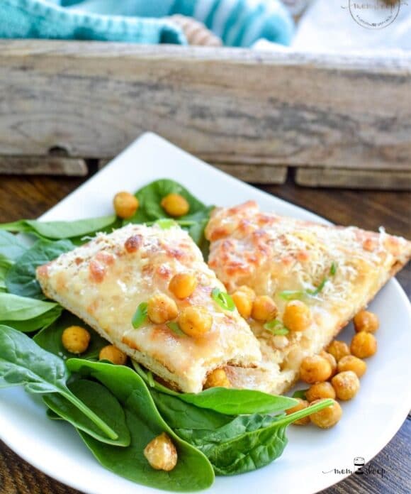 Garlic Flatbread on a white plate with spinach and chickpeas