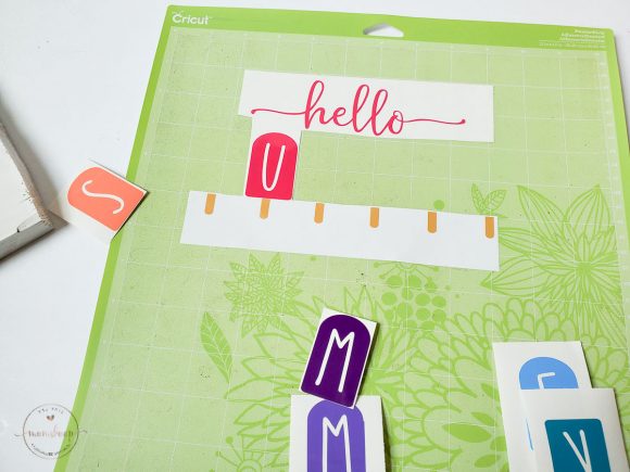 Cutting out the Hello Summer lettering out of vinyl for the Hello Summer Popsicle Plaque