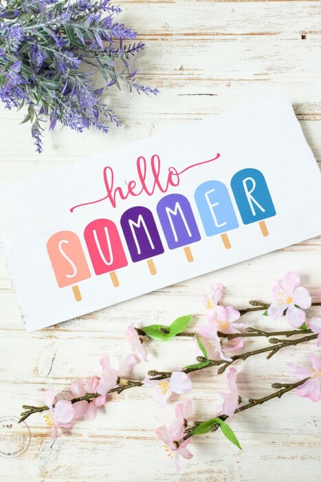 White Hello Summer Sign with different colors of popsicles.