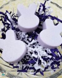 A glass bowl full of three Lavender Bunnies made from sugar scrub