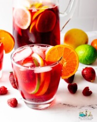 A glass of sangria with fruit