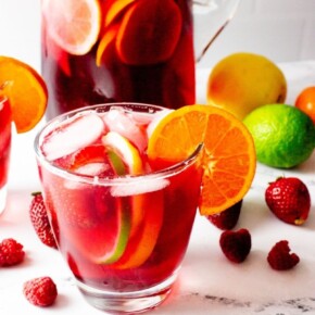 A glass of sangria with fruit