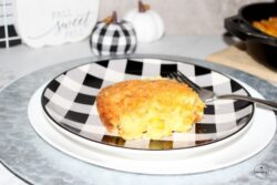 Easy to Make Cheese Corn Casserole on a buffalo plaid plate
