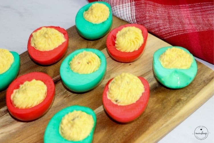 Christmas Deviled Eggs on a wooden board