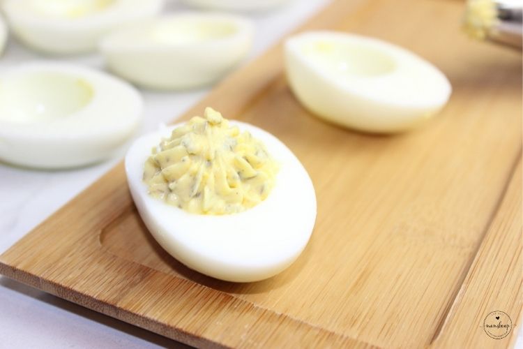 Deviled eggs on a bamboo board
