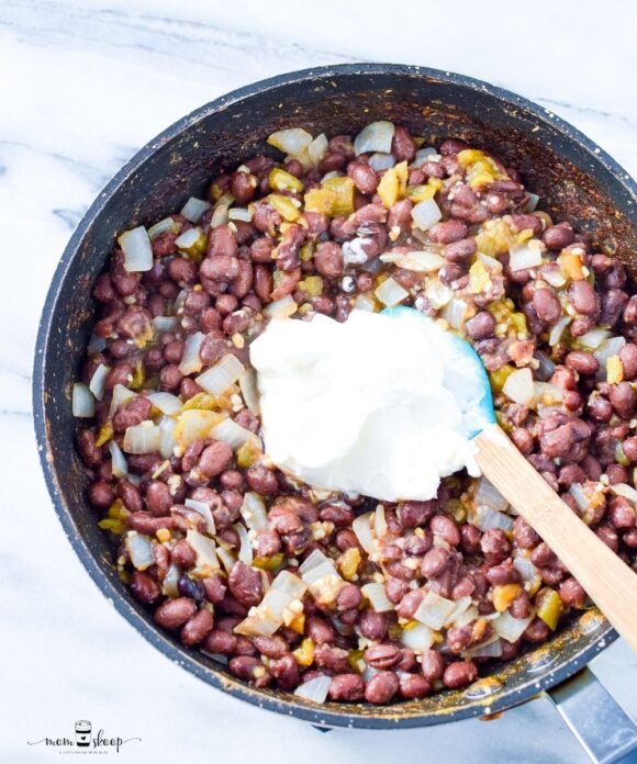 a skillet full of black beans and cream cheese