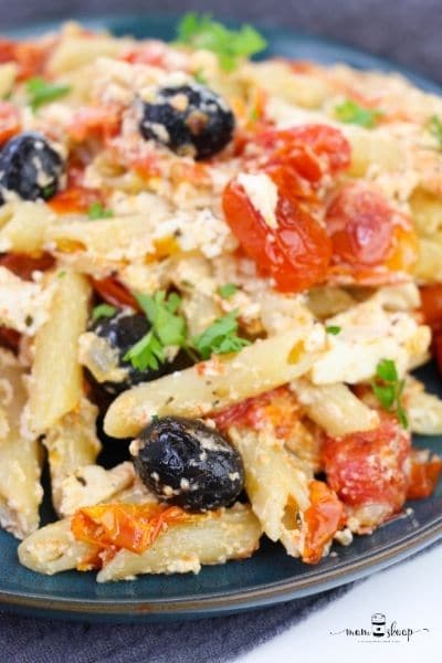 Closeup of pasta, black olives, tomatoes, and feta cheese