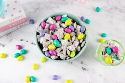 a blue bowl full of puppy chow and Easter M & Ms