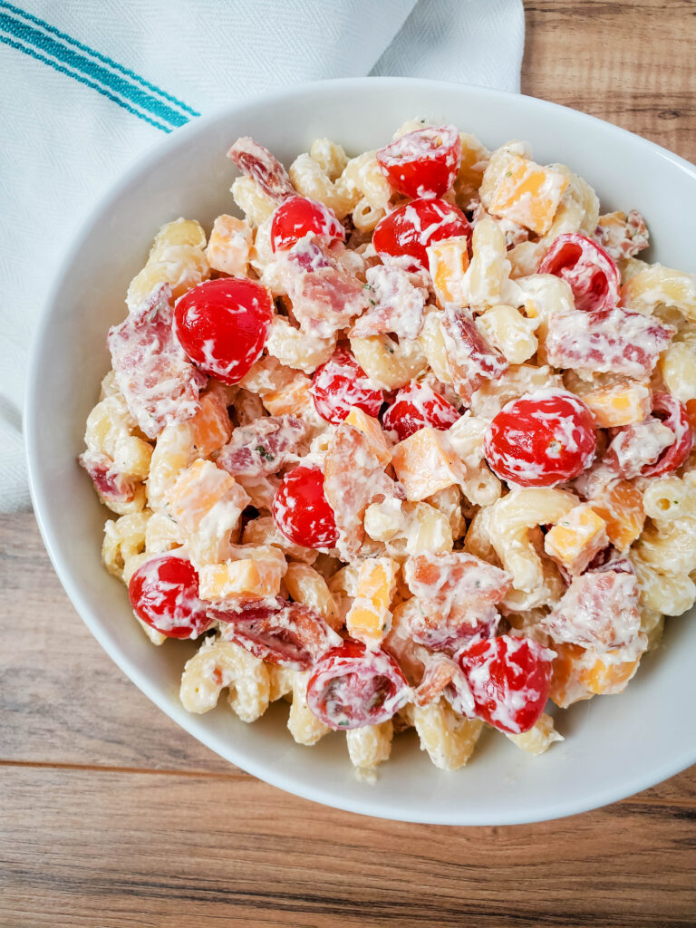 ranch pasta salad in a white bowl on a brown table