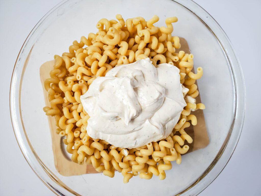 pasta and dressing together in a bowl