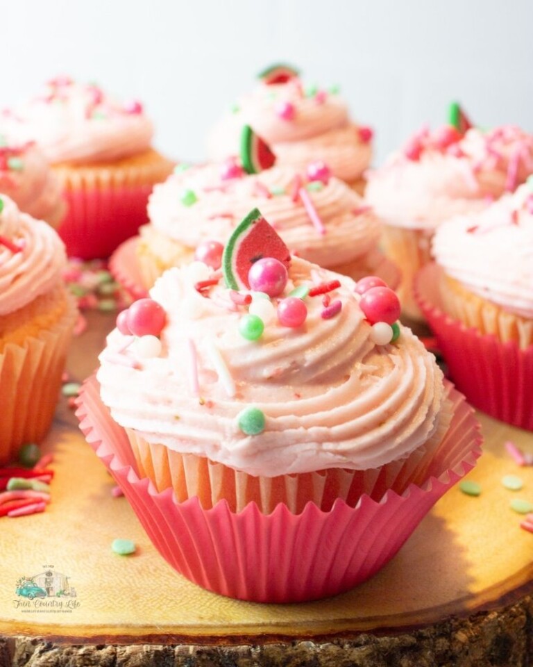 Strawberry Cupcakes with Watermelon Flavoring Oil on a wood plank
