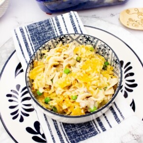 Tuna Noodle Casserole in a white and blue bowl on a white plate with blue designs
