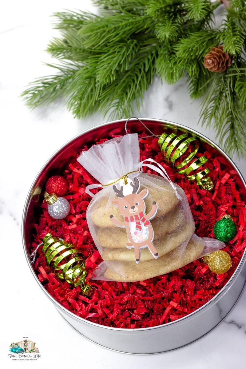 A favor bag full of Snickerdoodles and in a Christmas Tin