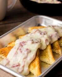 Four slices of texas toast topped with creamy chipped beef