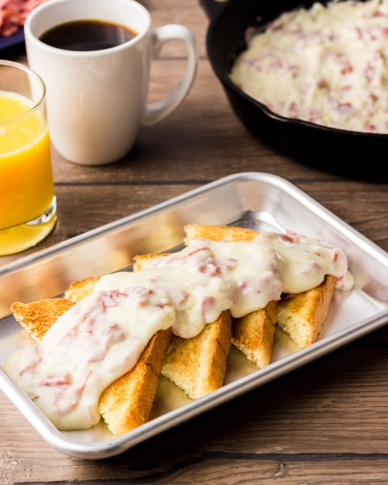 Creamed Chipped Beef in a metal pan ladled over Texas toast