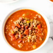 bowl of chili that has ground beef, tomatoes, green peppers, onions, beans, and celery