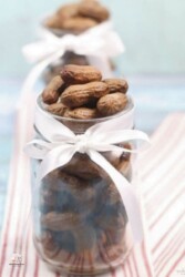 Southern-style boiled peanuts in a glass jar with a white ribbon around it
