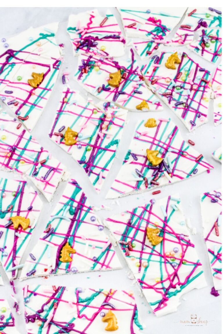White chocolate with pink, teal, and purple chocolate drizzle and unicorns and sprinkles