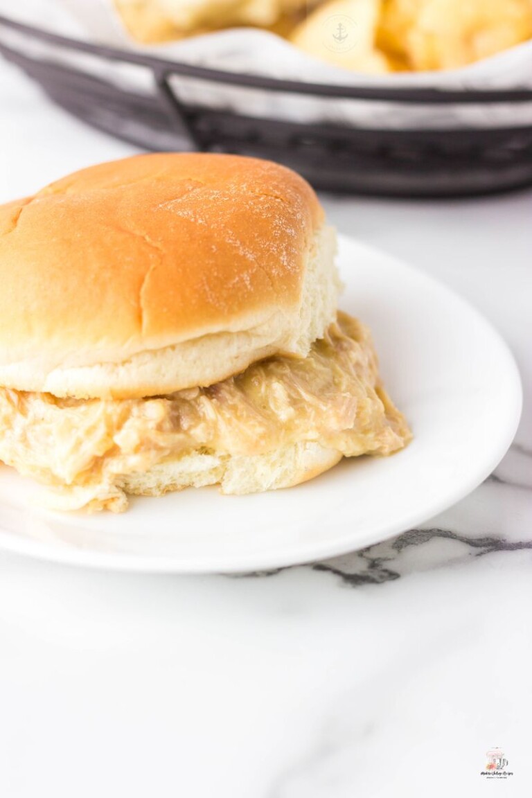 Sloppy Shredded Chicken on a bun that is on a white plate. Ohio Shredded Chicken Sandwich