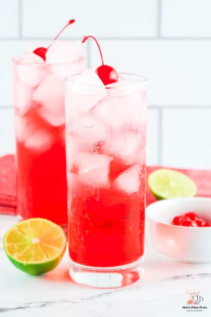 Shirley Temple mocktail with grenadine, sprite, lime, and cherries