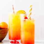 2 collins glasses full of orange juice, vodka, ice, grenadine syrup, and cherries