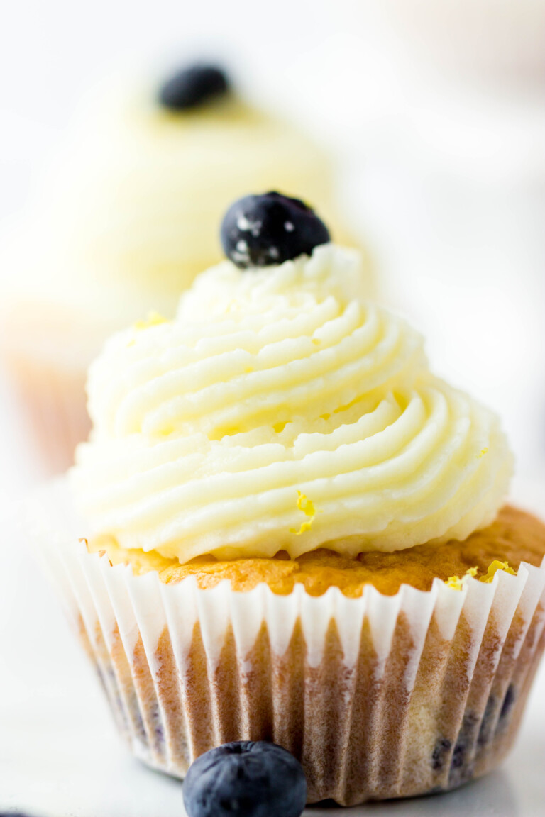 Lemon Blueberry Bisquick Cupcakes topped with frosting and blueberries