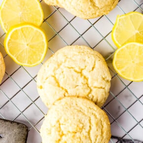 Lemon Cookies on a wire rack with slices of lemon
