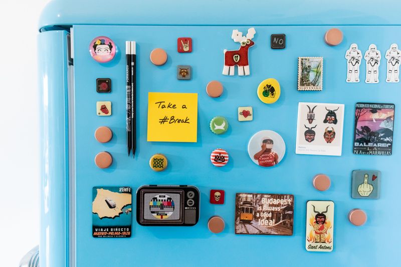 A Refrigerator Covered in Magnets, Notes, and Photos